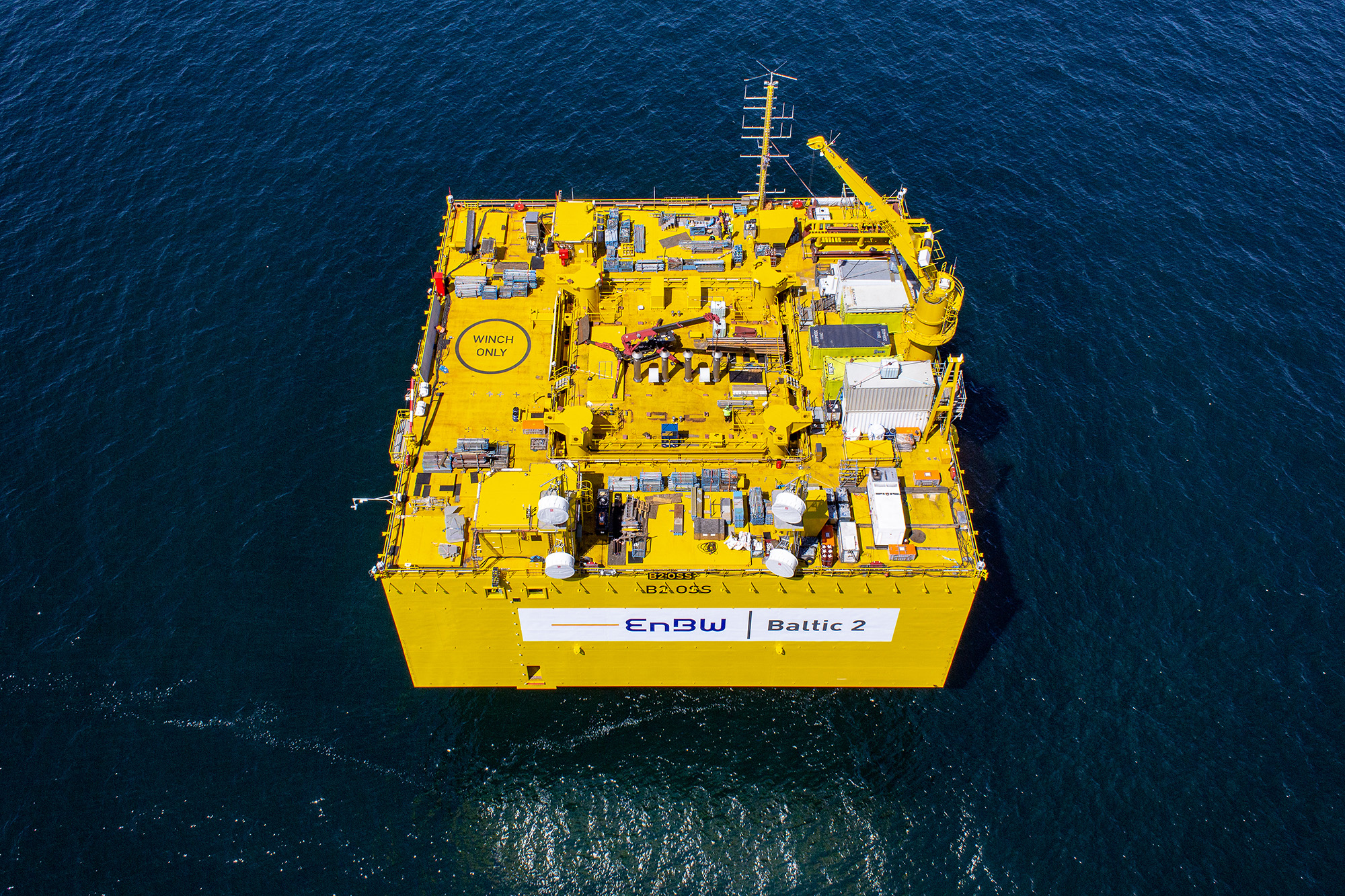 Offshore-Trafostation ENBW Baltic 2 aus der Luft, gelbe Plattform im Meer, technische Infrastruktur für Offshore-Windpark